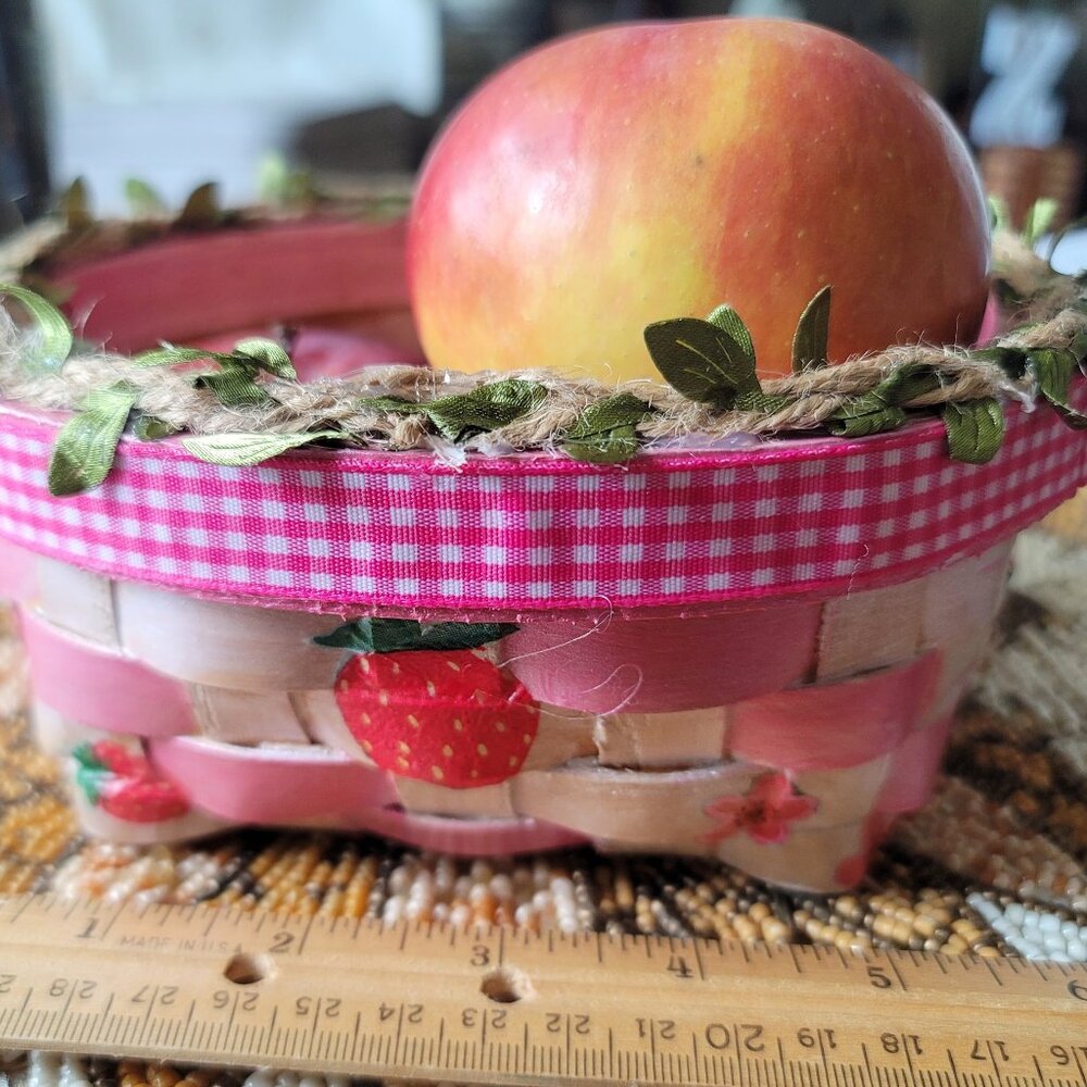 Strawberry Basket with Pink Ribbon & twine with leaves around the rim. Wicker